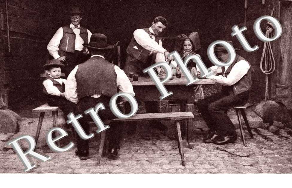 Quatre hommes et deux enfants a table  autour d'un kouglof