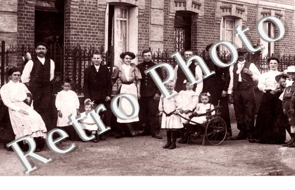 Hommes, Femmes et Enfants devant une maison