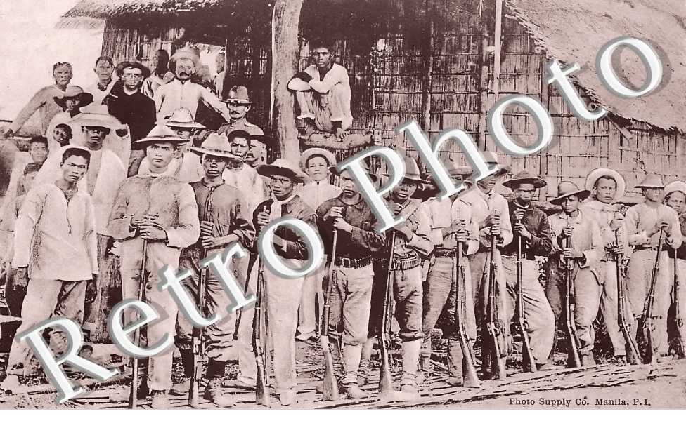 Insurgents waiting to give-up their arms at a surrender near Cebu
